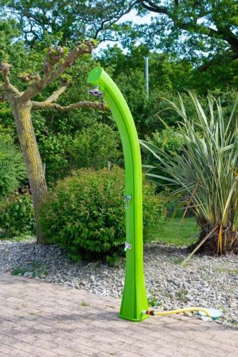 a green object sitting on the ground in a garden at GÎTE DE L'ODA in Le Poiré-sur-Vie