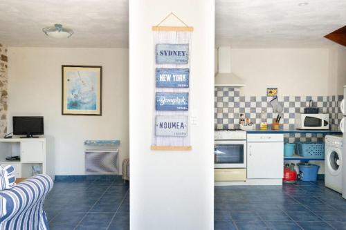 a kitchen with a refrigerator and a counter top at GÎTE DE L'ODA in Le Poiré-sur-Vie