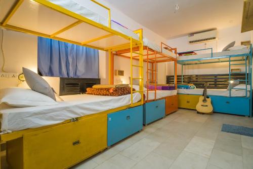 a room with two bunk beds and a guitar at Moustache Jaisalmer in Jaisalmer