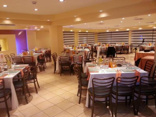 a dining room filled with tables and chairs at Mizpe Yam Boutique Hotel in Netanya