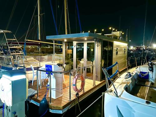 a boat docked in the water at night at Houseboat Seabreeze in Alghero