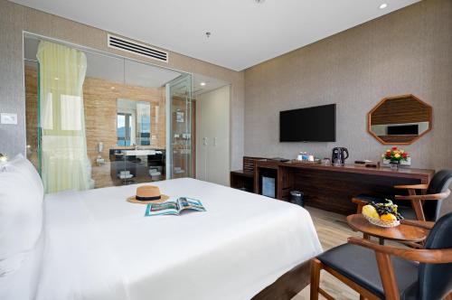 a hotel room with a bed and a television at Emerald Bay Hotel & Spa Nha Trang in Nha Trang