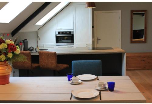 a kitchen with a table with two plates on it at BNBSpanbroek in Spanbroek