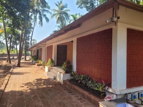 a house with a red brick at Cocorico Beach Resort in Dapoli