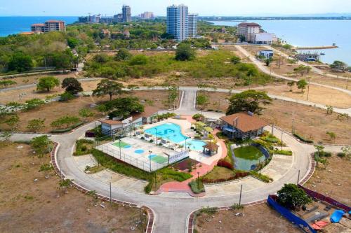 an aerial view of a resort with a swimming pool at Relaxing Stay with Sea View at Arterra in Mactan