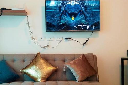 a movie poster hanging on a wall above a couch at Relaxing Stay with Sea View at Arterra in Mactan
