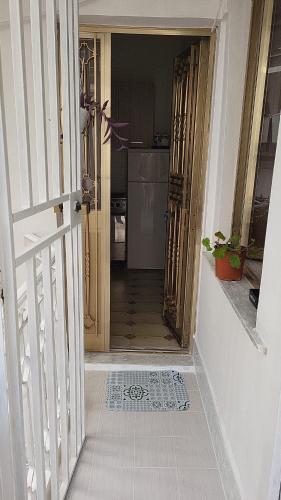 a hallway with a door leading to a kitchen at the lighthouse accommodation in Taranto