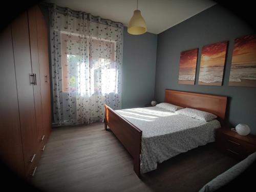 a bedroom with a bed and a window at Dianostellamarina in Diano Marina