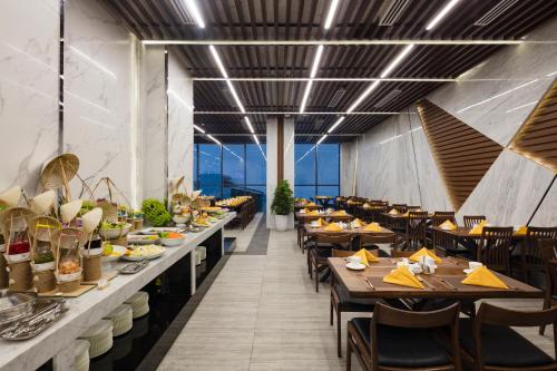 a dining room with long tables and chairs at Emerald Bay Hotel & Spa Nha Trang in Nha Trang