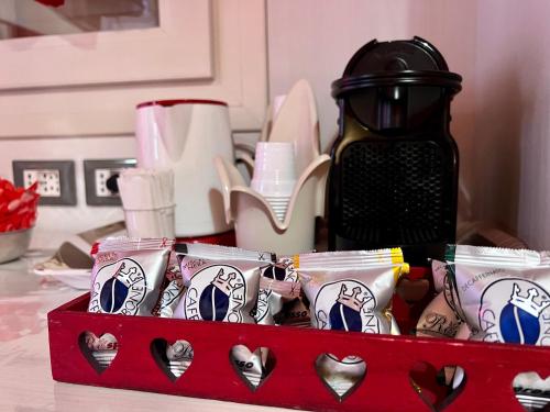 a red box filled with cups and a coffee maker at Agriturismo Le Essenze - Terrazza sulla Romagna in Cesena