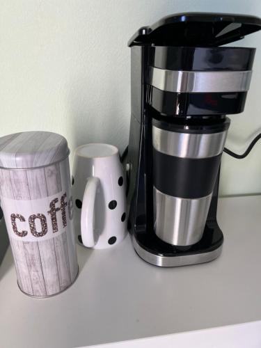 a coffee maker and a coffee mug on a counter at Ullis Pension für Monteure & Handwerker in Malsch