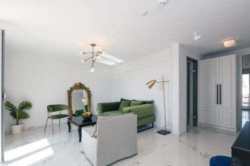 a living room with a green couch and a table at Jo An Palace in Rethymno Town