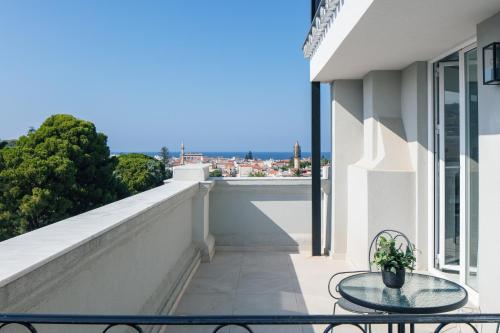 a balcony with a table and a view of the city at Jo An Palace in Rethymno Town
