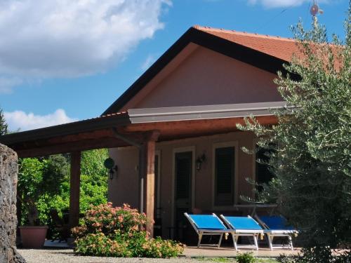 a house with blue picnic tables on the porch at Profumo di Zagara Acireale in Acireale