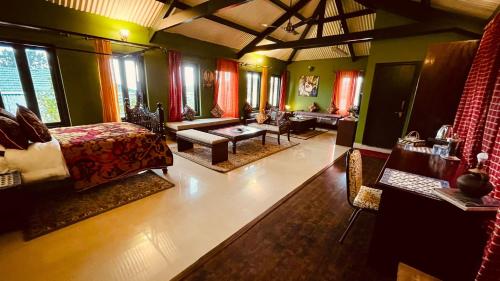 a large living room with a bed and a couch at Habba Kadal Kashmiri Heritage Hotel & Hub in Coonoor