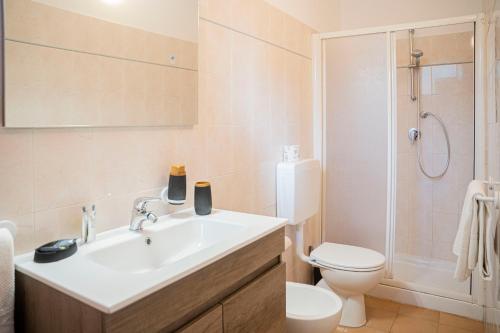 a bathroom with a sink and a toilet and a shower at Villaggio Smeraldo in Moneglia