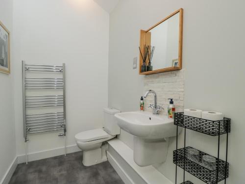 a bathroom with a toilet and a sink and a mirror at 1 Countess Chapel in Bath