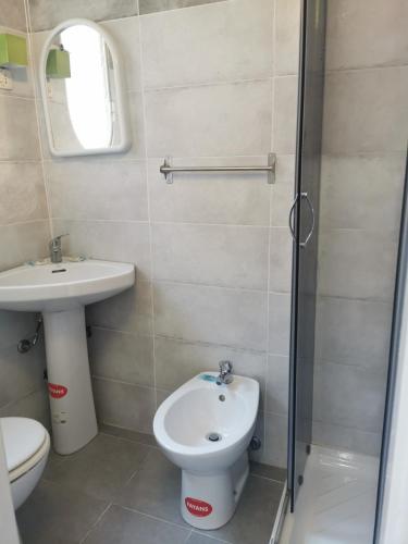 a bathroom with a toilet and a sink and a shower at locanda foresteria in Milan
