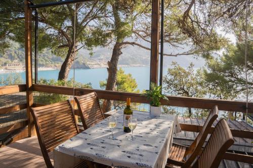 a table with a bottle of wine sitting on a porch at Villaggio Smeraldo in Moneglia