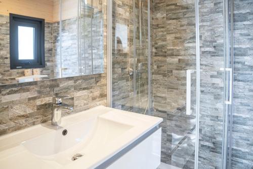 a bathroom with a sink and a glass shower at Villaggio Smeraldo in Moneglia