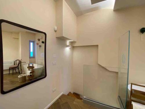 a mirror on a wall in a room with a staircase at Dimora Estlevante in Vieste