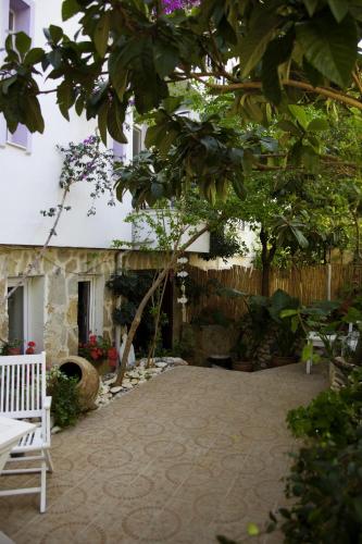 a garden with a bench and a building at Hideaway in Kas