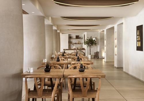 a row of tables and chairs in a restaurant at GARDELLI RESORT in Laganas