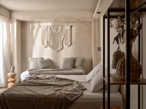a bedroom with two beds and a window at GARDELLI RESORT in Laganas