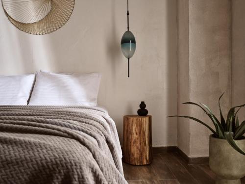 a bedroom with a bed and a potted plant at GARDELLI RESORT in Laganas
