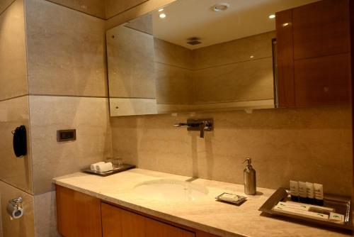 a bathroom with a sink and a mirror at Ramada Plaza by Wyndham Jammu Vijaypur in Jammu