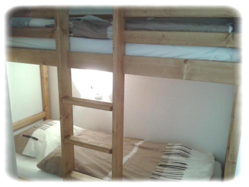 a bunk bed with several bunk beds in a room at Le Cernois -Centrre du village - pistes de luge, ski fond, patinoire, commerces à 100m in Prémanon