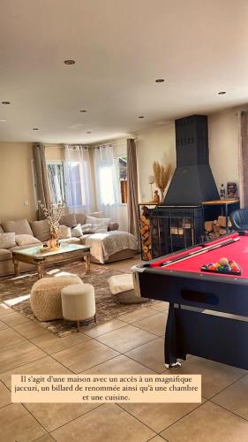a living room with a pool table and a fireplace at Golden housse in Pont-Sainte-Maxence