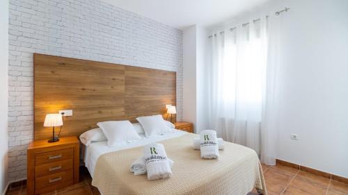 a bedroom with two beds with towels on them at Camino de la Huerta Montejaque by Ruralidays in Montejaque