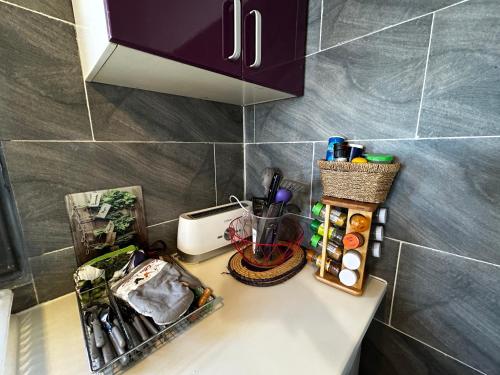 a counter top with items on it in a kitchen at Appartement entier, T2 cosy à Mamoudzou in Mamoudzou