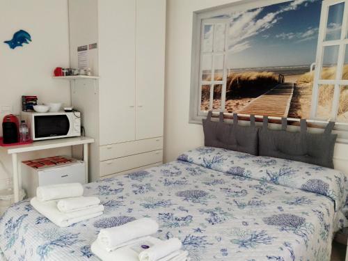 een slaapkamer met een bed met handdoeken erop bij La Casa di Berenice a Porto Azzurro in Porto Azzurro