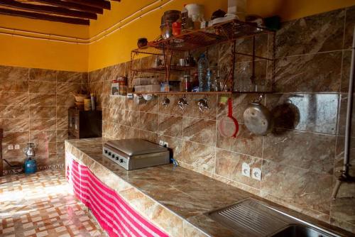 a kitchen with a counter with a toaster on it at Maison etoile du desert in Tighmert