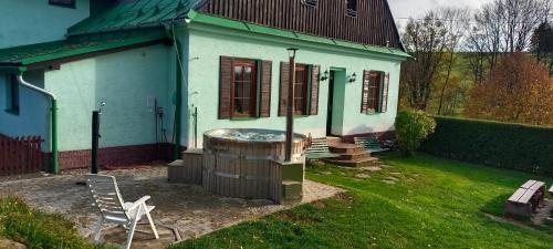 a house with a hot tub in the yard at Penzion Severka in Rokytnice v Orlických Horách