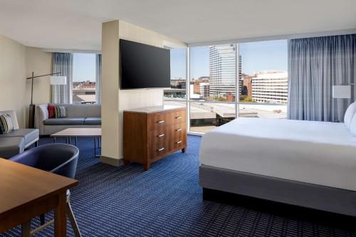 a hotel room with a bed and a large window at Hyatt Regency Baltimore in Baltimore