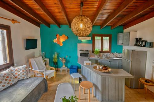 a kitchen and living room with blue walls at Villas Vista Del Mar in Kissamos