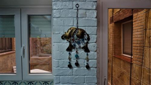 a clock hanging on a brick wall next to a door at Casa torre del Carmen Cazorla II in Cazorla