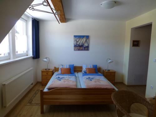 a bedroom with two beds and two windows at Ubytování Edita in Boží Dar