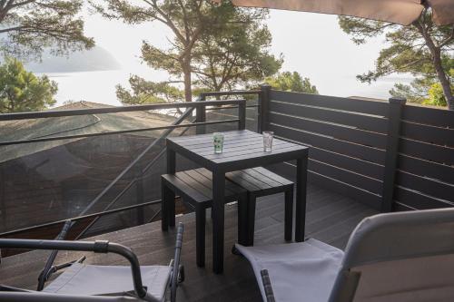 a small table and chairs on a balcony with a view at Villaggio Smeraldo in Moneglia