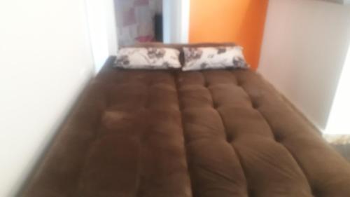 a bed in the corner of a room at Parada Di Maria Guest House in Campos do Jordão