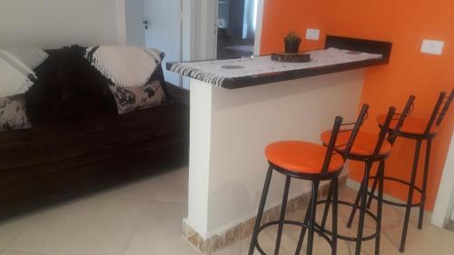 a kitchen with two stools and a counter in a room at Parada Di Maria Guest House in Campos do Jordão