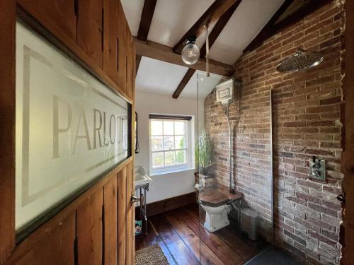 a room with a brick wall and a window at Riverside Mews - Yarm High Street in Yarm