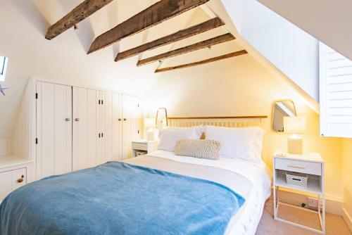 a bedroom with a large bed with a blue blanket at Portobello Court in Kent