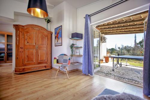 a living room with a wooden door and a table at villa yvonne,private pool,private parking 1,7 km from the beach in Albufeira