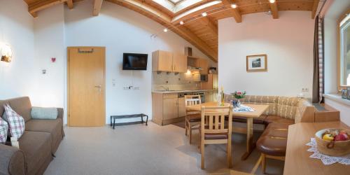 a kitchen and living room with a table and chairs at Haus Fernblick in Neustift im Stubaital