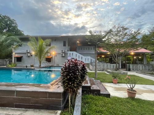 a house with a swimming pool in the yard at Pangkor Nature View House in Pangkor