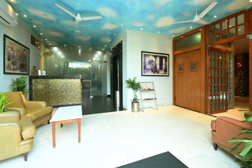 a living room with a couch and a table at Hotel Yulia in Jaipur